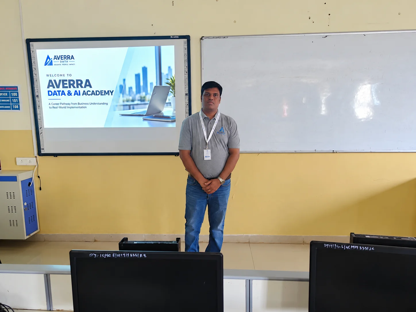A trainer standing in front of a screen that reads Welcome to Averra Data and AI Academy